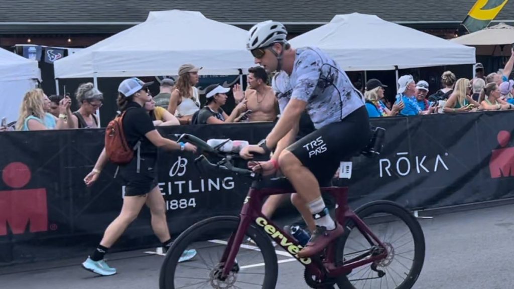 Michael Kemp, 30, of Kona, leaving downtown Kailua-Kona to tackle the VinFast Ironman World Championship bike course. (Tiffany DeMasters/Big Island Now)
